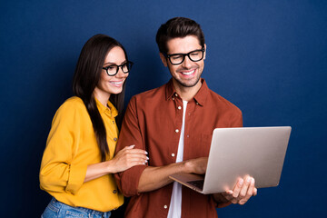 Aufkleber - Portrait of two attractive positive colleagues use wireless netbook develop project isolated on blue color background