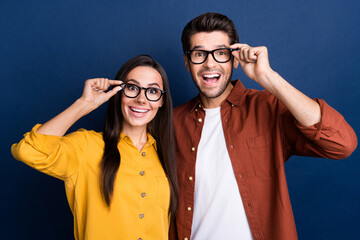 Sticker - Portrait of two astonished corporate workers hand touch eyewear open mouth unbelievable isolated on blue color background