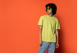 © ADDICTIVE STOCK - Confident young ethnic man in sunglasses standing near turquoise backdrop