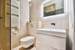 © ADDICTIVE STOCK - Bathroom with mirror over sink and toilet bowl