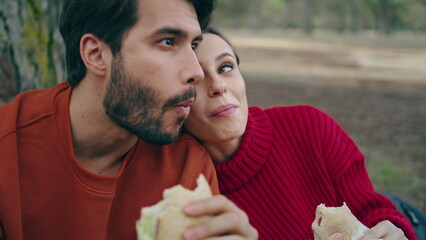 Couple tourists eating forest enjoying beautiful nature close up. Happy family 