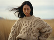 Beautiful young Asian woman in beige knitwear sweater.	