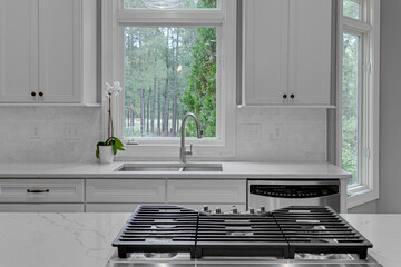 Wall Mural - Stylish Modern Kitchen with White Cabinets and a View of Nature, Clean and Serene