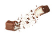 Broken chocolate bar with shredded coconut in air on white background