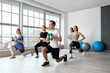 © Pixel-Shot - Group of sporty young people training in gym