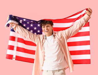 Wall Mural - Happy young man with USA flag on pink background