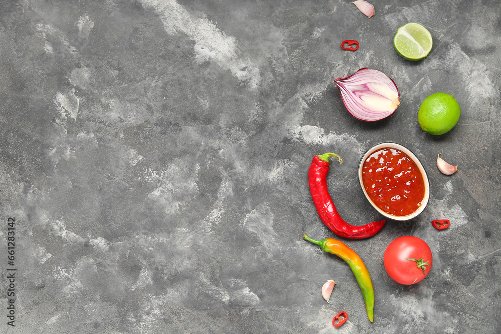 Bowl with tasty salsa sauce and ingredients on grey background
