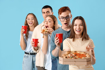 Canvas Print - Group of young friends with tasty pizza and beer on blue background