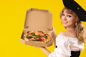 Poster - Young woman dressed for Halloween as pirate with tasty pizza on yellow background