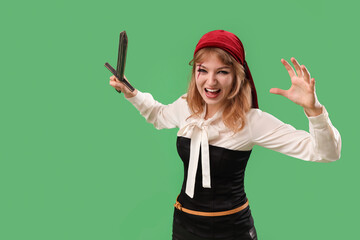 Poster - Scary young woman dressed for Halloween as pirate with sword on color background