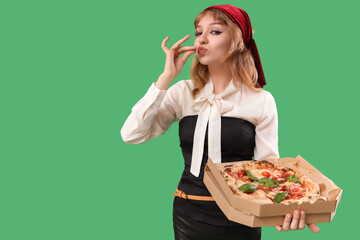 Poster - Young woman dressed for Halloween as pirate with tasty pizza on green background