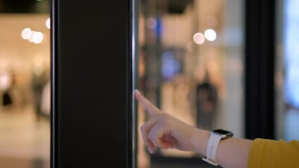 Girl using a touch terminal in a shopping mall. The concept of people and technologies. Online Router