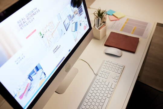 Website, planning and a computer screen in an office, table or workspace connection. Strategy, business and a desktop pc at a desk for company information, web design or online graphic creativity