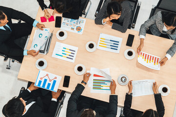 Business people group meeting shot from top view in office . Profession businesswomen, businessmen and office workers working in team conference with project planning document on meeting table . Jivy