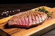 tuna steak showing sear marks, on a board