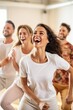 © piai - A group of diverse individuals engaging in a fun and energetic dance class, showcasing their enthusiasm and joy