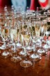 © Wirestock - Array of sparkling crystal glasses filled with champagne atop a rustic wooden table