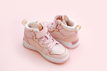 Wall Mural - Children's sneakers. Baby sneakers on pink background. .Trendy sneakers for kids for spring and autumn. Fashion kids outfit.