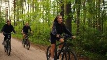 Cycling In Forest In Summertime For Stay Slender And Beautiful, Group Of Young Adult Women