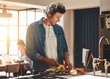 © Arnell K/peopleimages.com - Cooking, food and man cutting vegetables in the kitchen for diet, healthy or nutrition dinner. Recipe, book and mature male person from Canada chop ingredients for a supper or lunch meal at home.