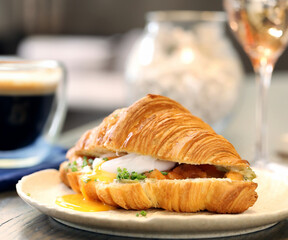 traditional croissant with salmon and egg for breakfast