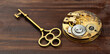 Gold vintage key with pocket watch on wooden background. Escape room game, success banner.
