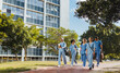 © Jacob Lund - Team of medical students walking along a university hospital campus
