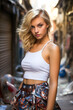Blonde teen in miniskirt poses in graffiti alley.