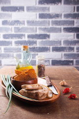 Wall Mural - Pork fatback with spices, rye bread and green onion on wooden table