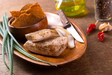 Poster - Pork fatback with spices, rye bread and green onion on wooden table