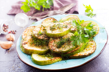 Poster - fried squash with oil and garlic on blue plate