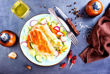 Canvas Print - Marinated grilled healthy chicken breasts cooked on a summer BBQ and served with fresh herbs on plate