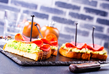 Wall Mural - Whole grain bread sandwiches with prosciutto and avocado. Clean eating, healthy breakfast. Top view, flat lay