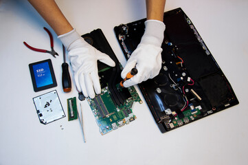 Fototapete - Top view. Technician repairing notebook computer, repairing motherboard and circuit.