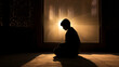 © jxvxnism - silhouette of a muslim boy praying in a mosque