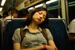 © Konstiantyn Zapylaie - Girl passenger sleeps in a subway car, train
