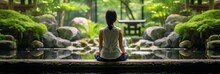 Zen Moment: Woman In Lotus Pose, Lost In Thought Within A Verdant Meditation Garden Banner