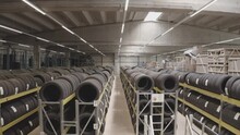 Tire factory. Warehouse. Storehouse. Factory storage with racks and tires. Industrial interior.