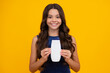 © Olena - Teen child girl with shampoo bottle or shower gel isolated on yellow background. Kids hair cosmetic product. Happy girl face, positive and smiling emotions.