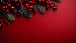 Beautiful celebratory Christmas red background with fir or pine branches and rowan berries. New Year's holidays. Top view with copy space