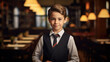 © Studio Nova - Portrait of a little boy dressed as a waiter. The concept of children in adult occupations.