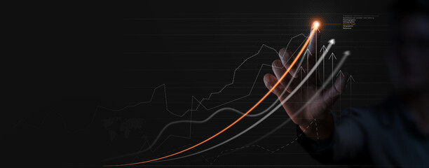 Businessman analyzing company financial balance sheet working with digital virtual graphics  ghaph chart. Businessman calculating financial data for long term investment growth goals,