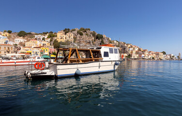 Wall Mural - Colorful traditional fishing boats in the bay of Symi island.