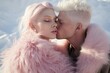 © Glittering Humanity - Portrait of a beautiful couple in a pink winter fur jacket. Pastel desert, fresh winter morning. Alien world on another planet. Glitter make up, pale skin,  surreal landscape. Love kiss relationship.