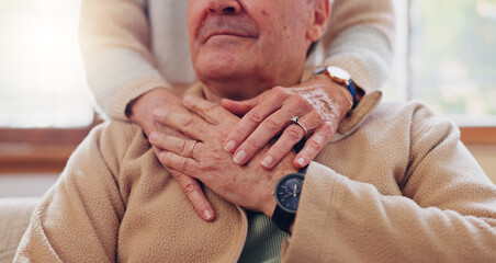 Hands, empathy and a senior couple closeup in their home for love, support or trust during retirement. Hope, healing and sympathy with elderly people on a sofa in the living room of their home