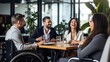 © masyastadnikova - Business meeting in a co-working space by a man in a wheelchair. Integration of people with disabilities.