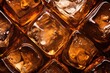 Macro close up of ice cubes in whiskey or another alcoholic beverage featuring a crystal design against a textured background