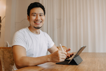 Wall Mural - Happy smile freelance asian man work in the cafe.