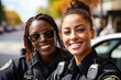 © TRINETTE + CHRIS - Portrait of Black women police officers on street smiling