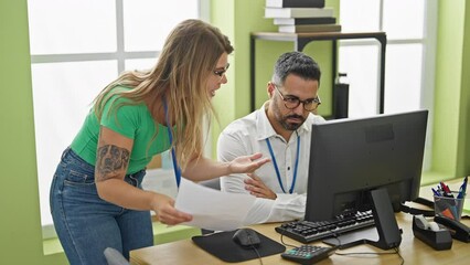 Canvas Print - Man and woman business workers using computer arguing at office